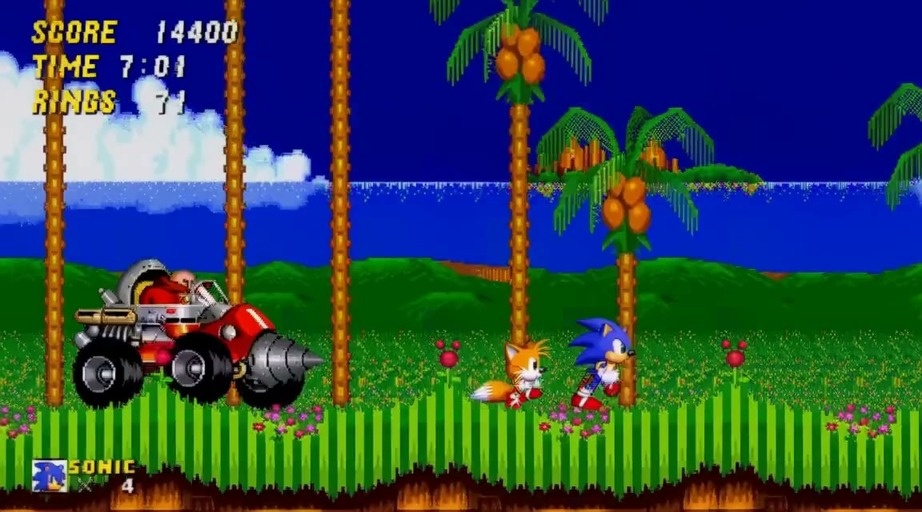 Sonic and Tails running from Dr. Robotnik in a drill vehicle during a Sega Genesis style game level.